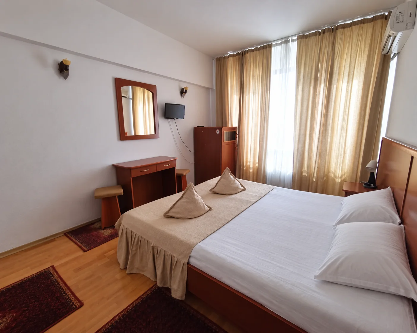 Double bed with beige bedspread
