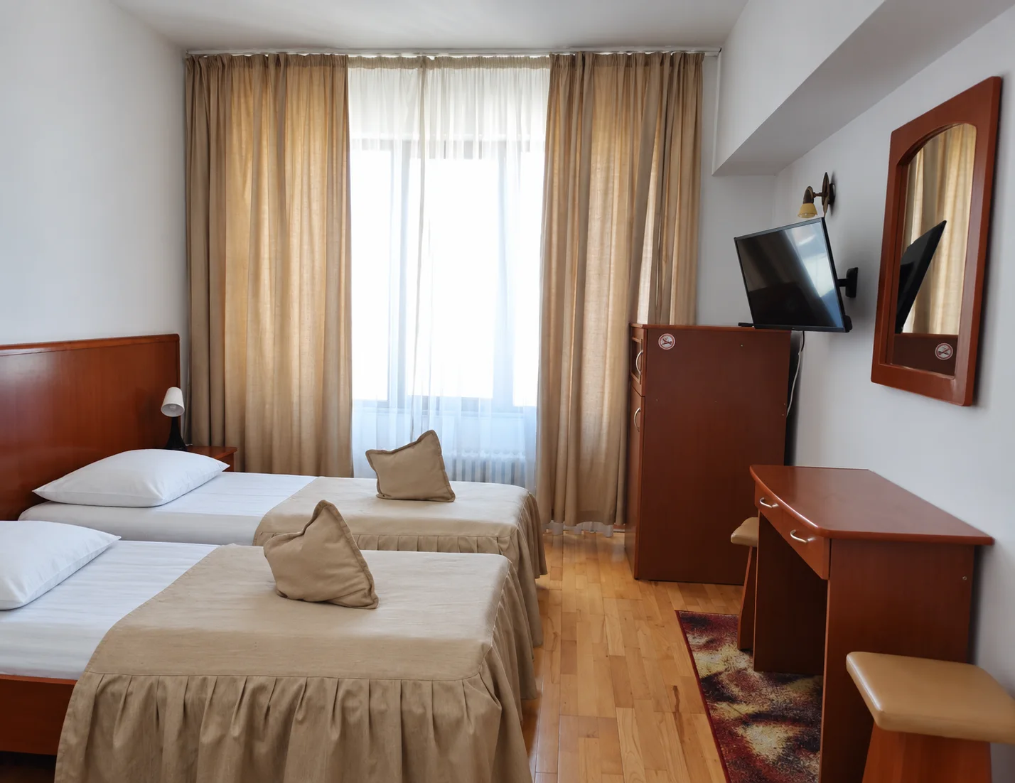 Twin beds with beige bedspreads