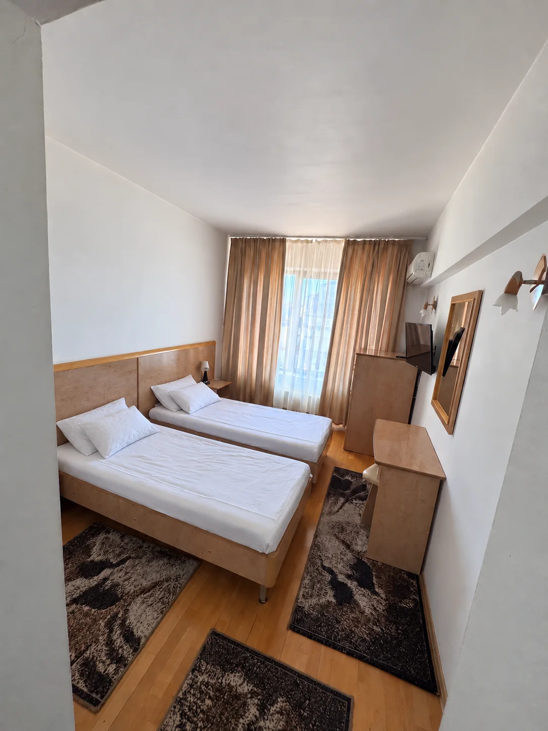 Twin beds — light wood furniture